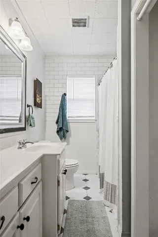a view of a workspace room with wooden floor and a window