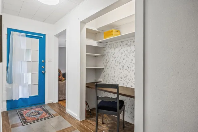 a living room with furniture and a ceiling fan