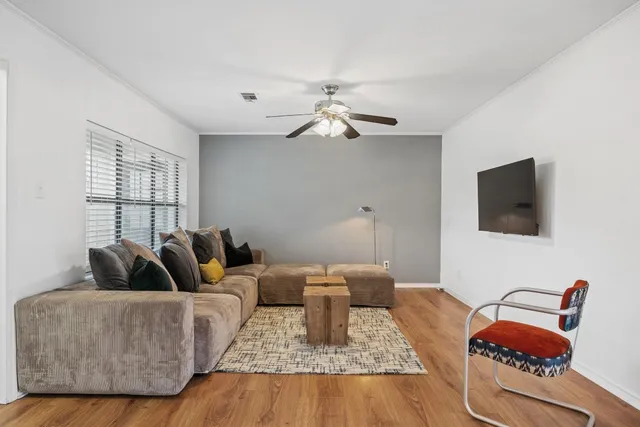 a living room with stainless steel appliances furniture and a window