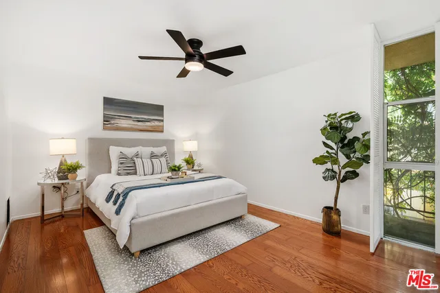 a bedroom with a bed and a potted plant