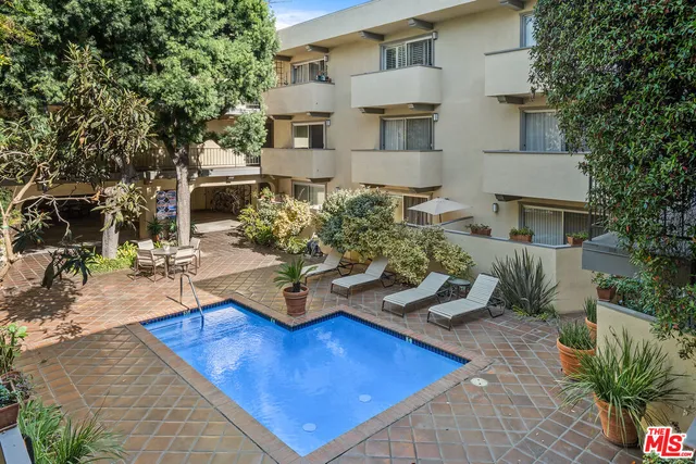 a view of a backyard with plants and a patio