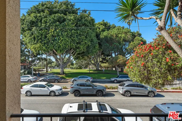 a view of cars parked on the side of a street