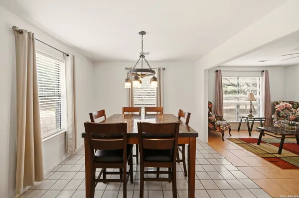 a living room with furniture and large windows
