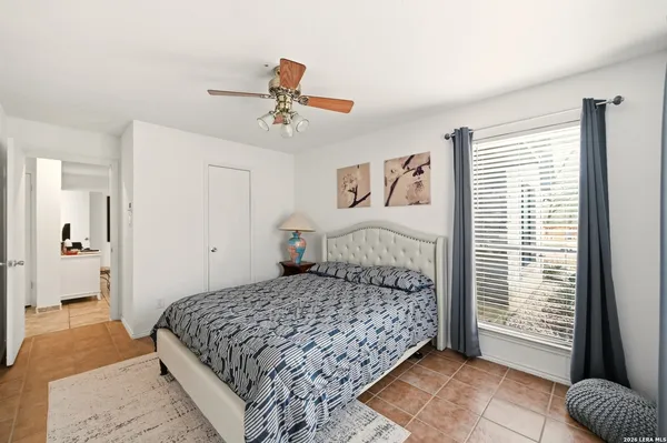 a bedroom with a bed and a window