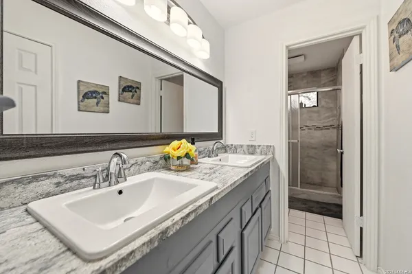 a bathroom with a toilet a sink and a mirror