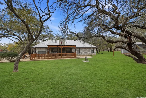 a view of a house with a yard covered with snow