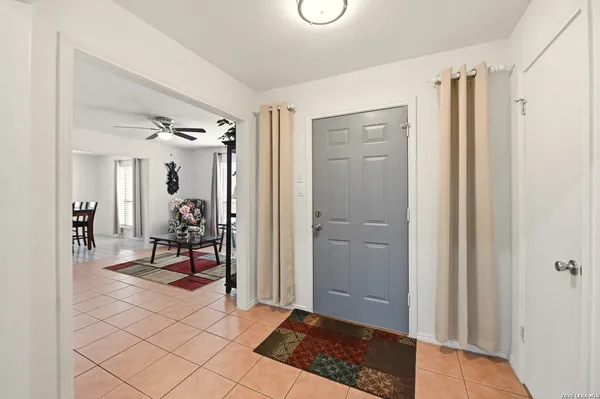 a bedroom with furniture and a large window