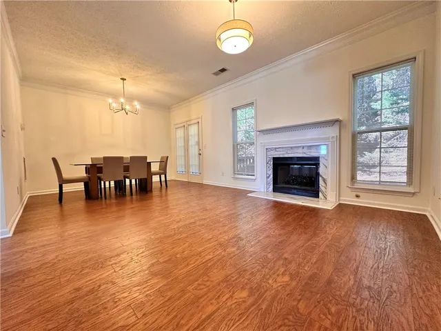 a view of a livingroom with furniture fireplace and wooden floor