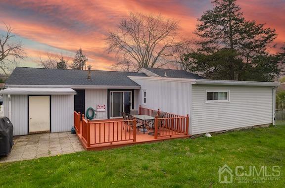 92 Kendall Road Kendall Park, NJ 08824 - Photo 24 of 28 back house at dusk featuring a deck and a yard