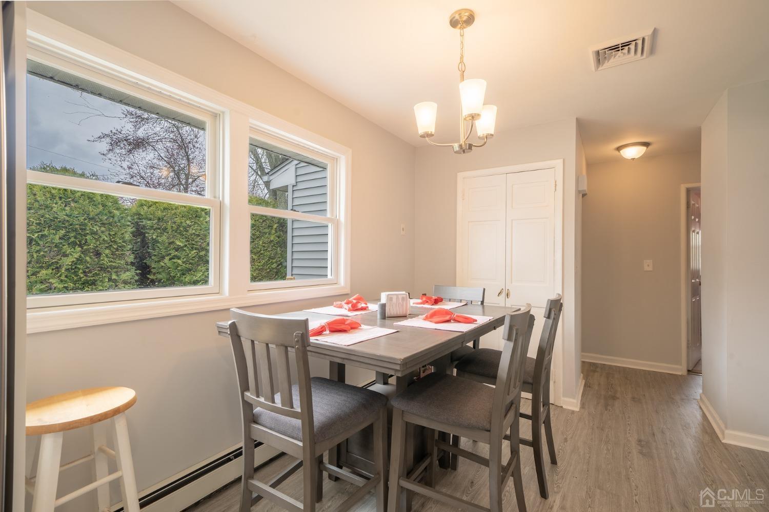 92 Kendall Road Kendall Park, NJ 08824 - Photo 5 of 28 dining room with hardwood / wood-style flooring and a chandelier
