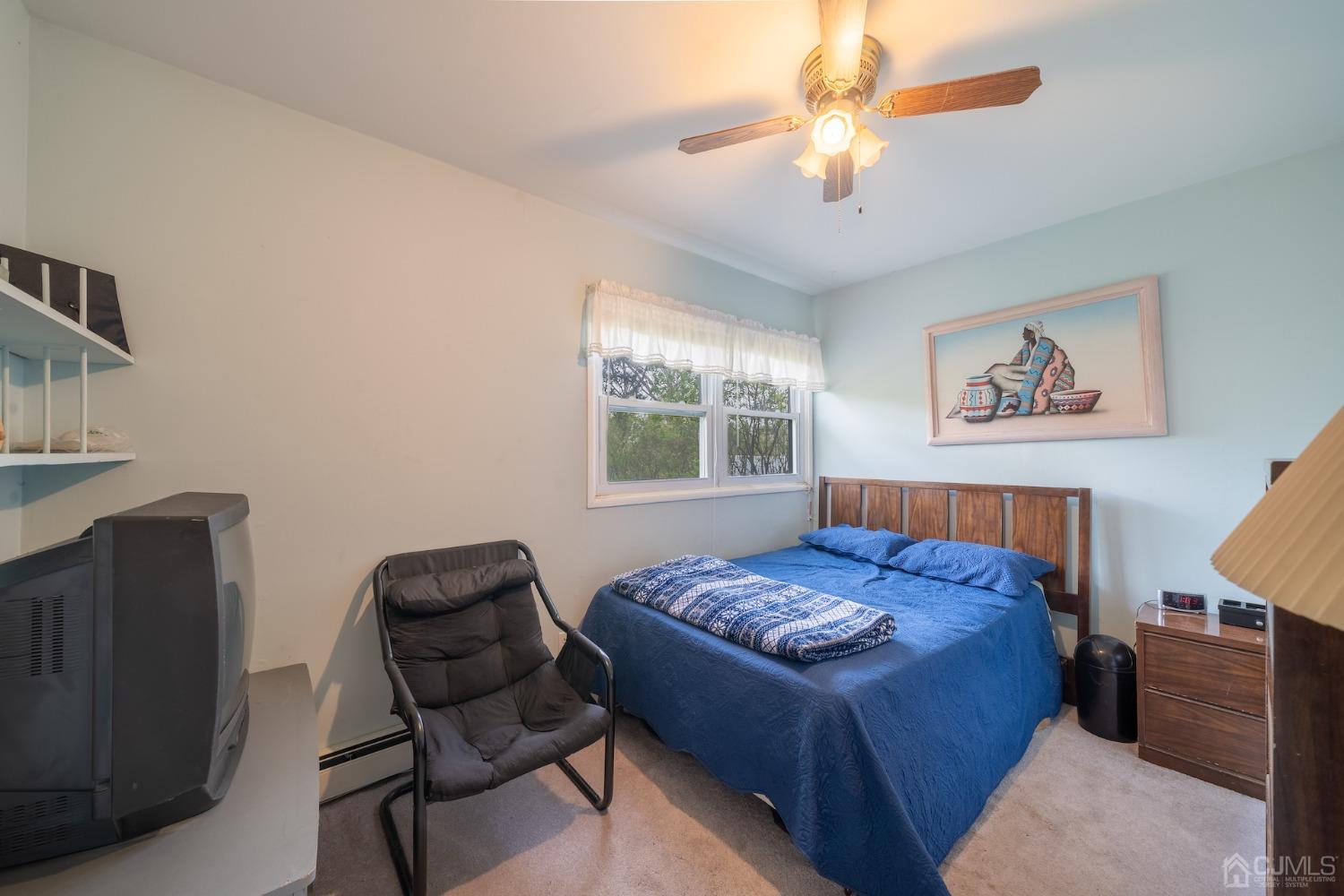 92 Kendall Road Kendall Park, NJ 08824 - Photo 7 of 28 carpeted bedroom with ceiling fan and a baseboard radiator