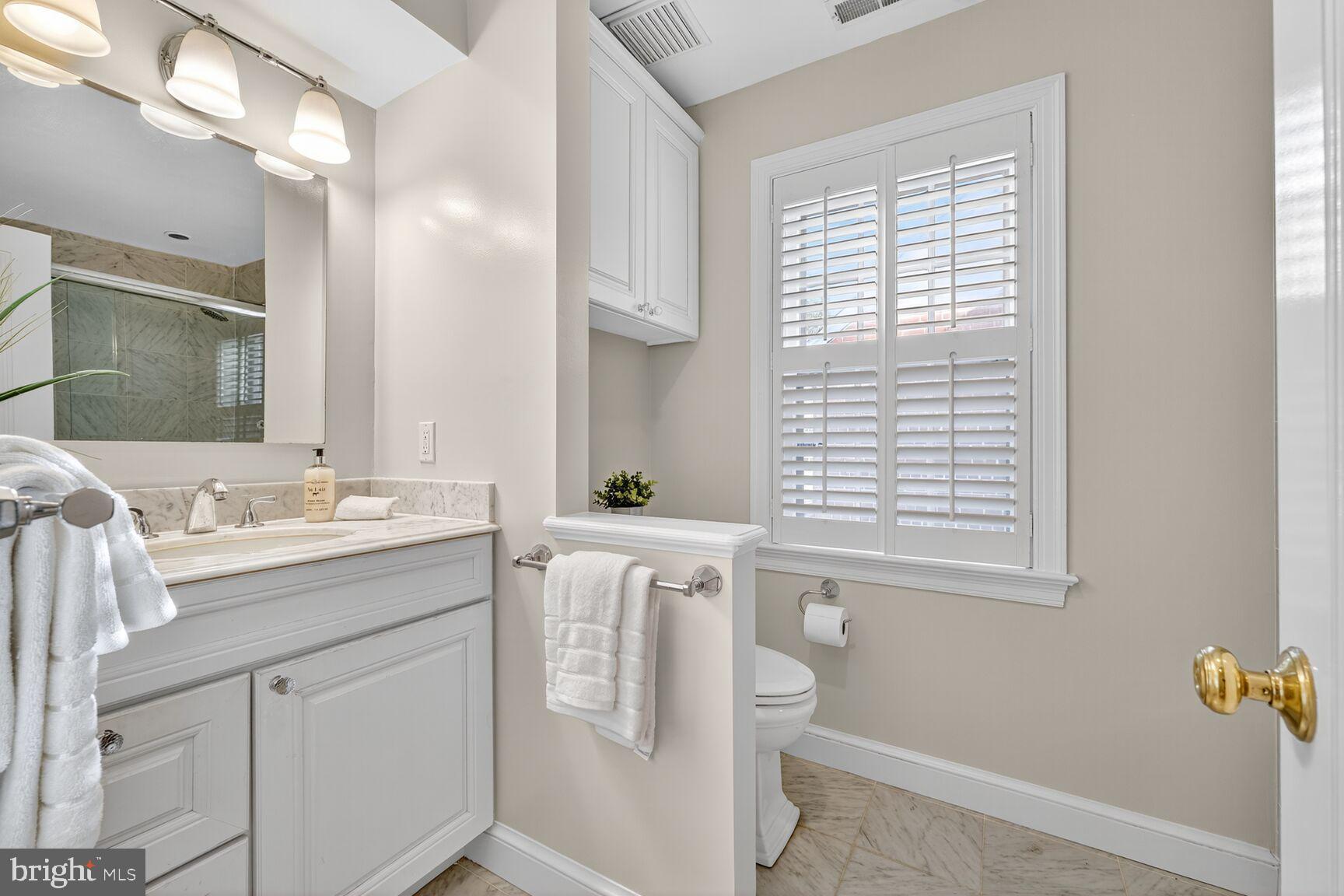 3293 Worthington Street Northwest Washington, DC 20015 - Photo 17 of 45 a bathroom with a sink a vanity and a mirror