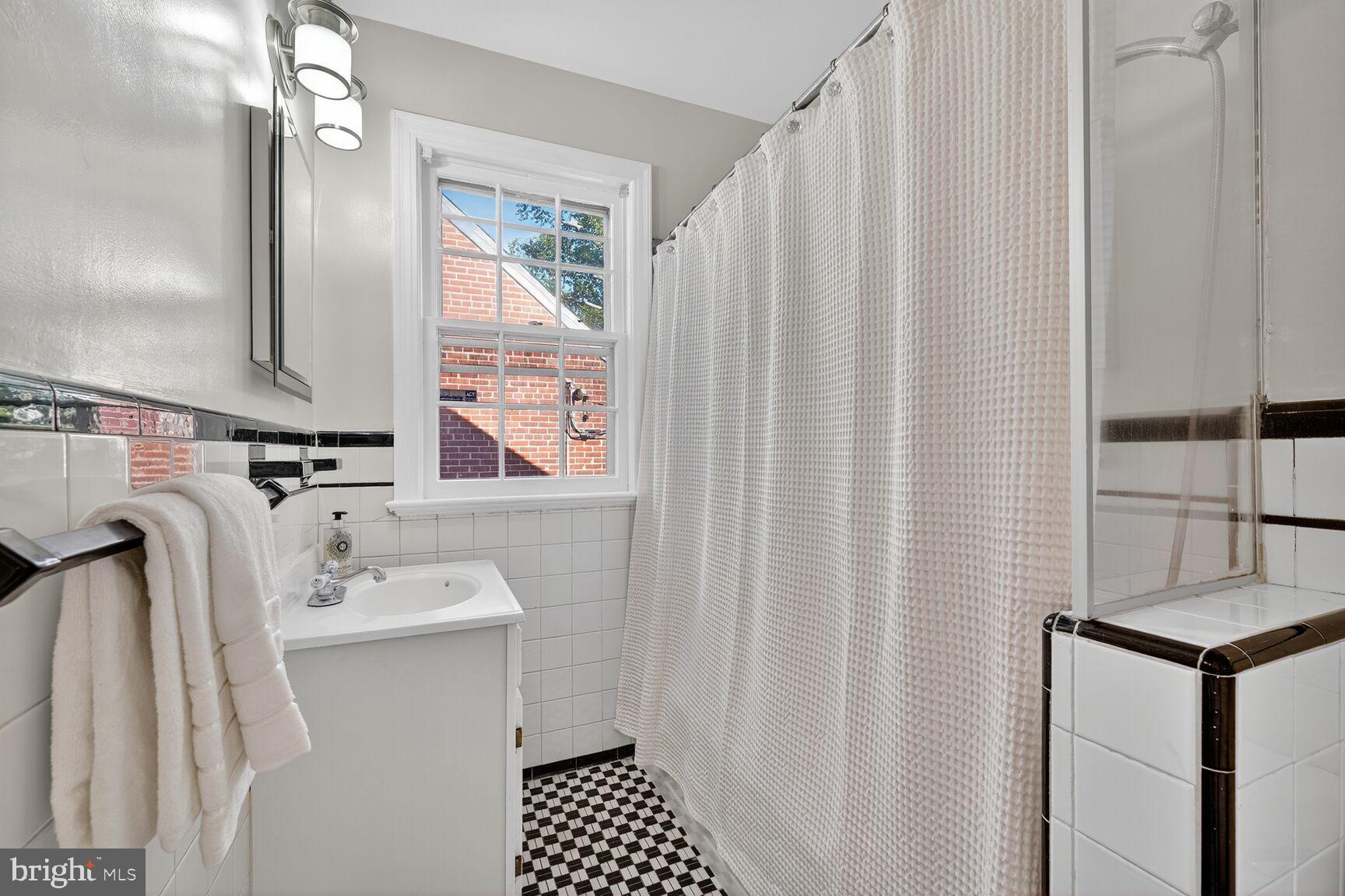 3293 Worthington Street Northwest Washington, DC 20015 - Photo 20 of 45 a bathroom with a sink toilet and shower