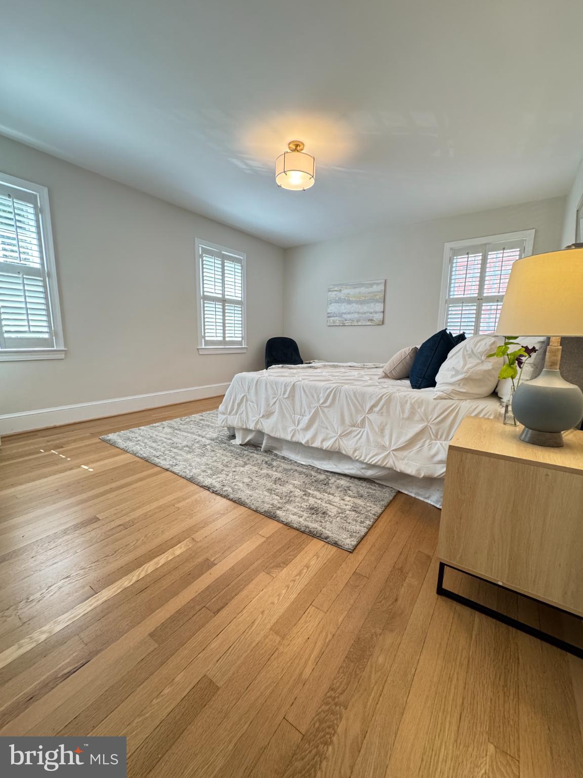 3293 Worthington Street Northwest Washington, DC 20015 - Photo 22 of 45 a bedroom with a bed and a lamp on dresser