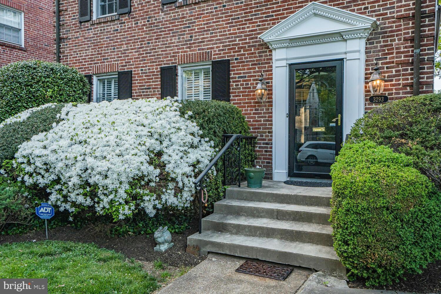 3293 Worthington Street Northwest Washington, DC 20015 - Photo 40 of 45 a view of a house with potted plants and a bench