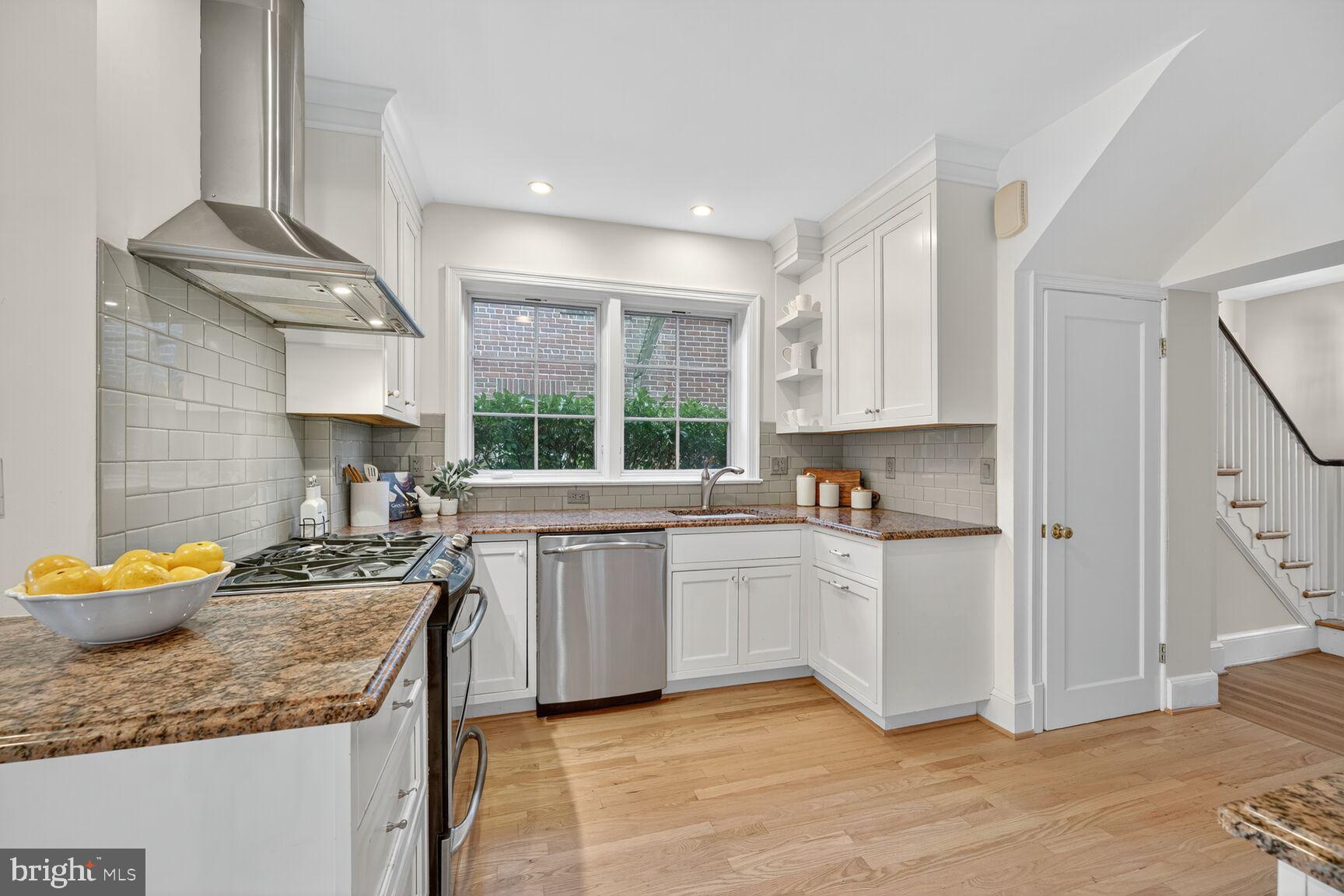 3293 Worthington Street Northwest Washington, DC 20015 - Photo 6 of 45 a kitchen with stainless steel appliances granite countertop a sink and a stove