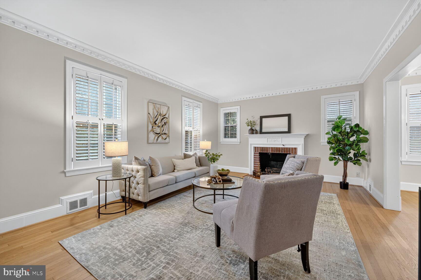 3293 Worthington Street Northwest Washington, DC 20015 - Photo 8 of 45 a living room with furniture a large window and a fireplace