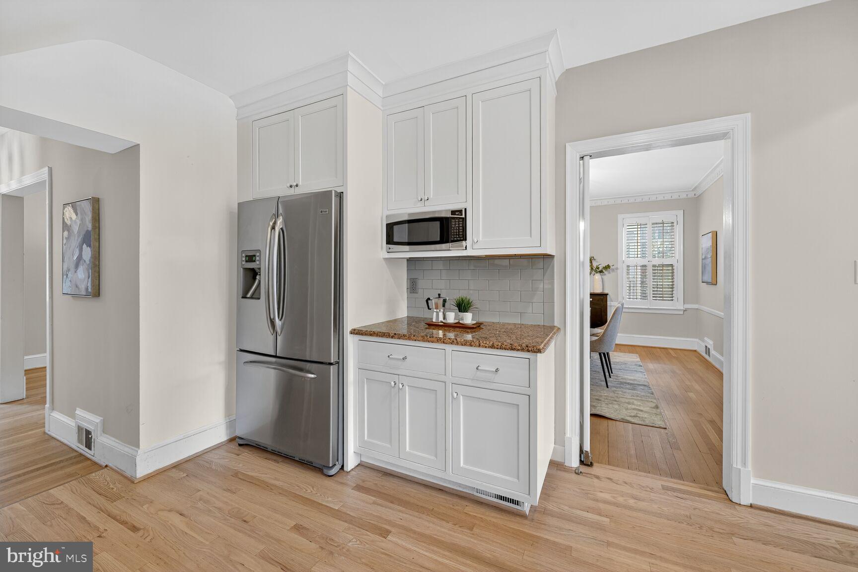 3293 Worthington Street Northwest Washington, DC 20015 - Photo 10 of 45 a kitchen with a refrigerator stove and wooden cabinets