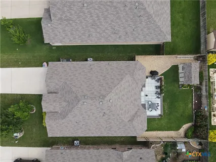 an aerial view of a house with a yard