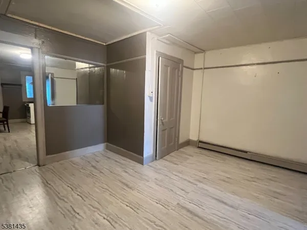 a view of hallway with wooden floor