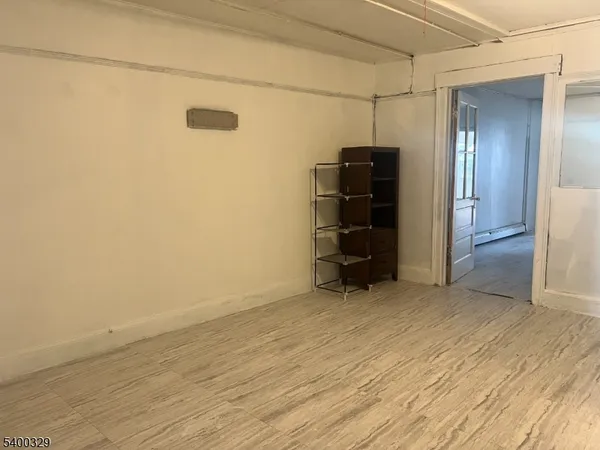 a view of empty room with closet and cabinet