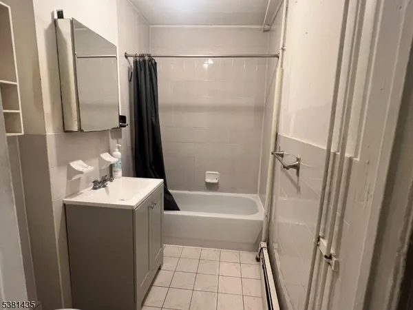 a bathroom with a sink a mirror toilet and bathtub