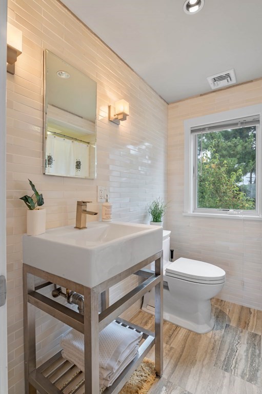 13 Goldthwait Road Marblehead, MA 01945 - Photo 25 of 40 a bathroom with a sink toilet a mirror and bathtub