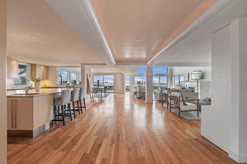 13 Goldthwait Road Marblehead, MA 01945 - Photo 7 of 40 an open kitchen with dining table and wooden floor