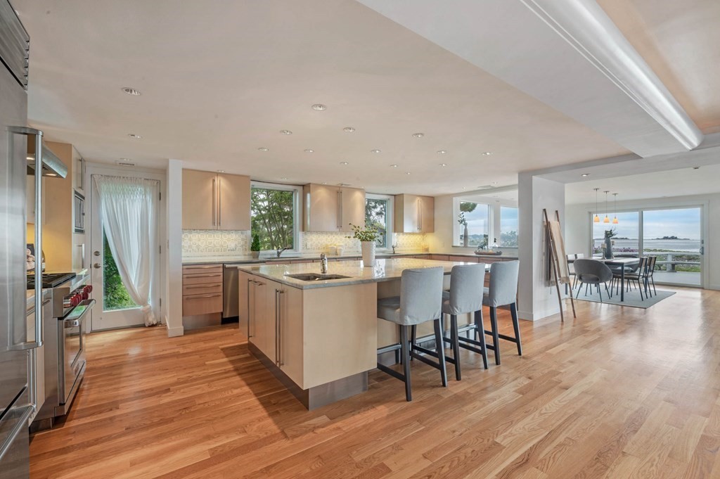 13 Goldthwait Road Marblehead, MA 01945 - Photo 9 of 40 a kitchen with a table chairs refrigerator and cabinets