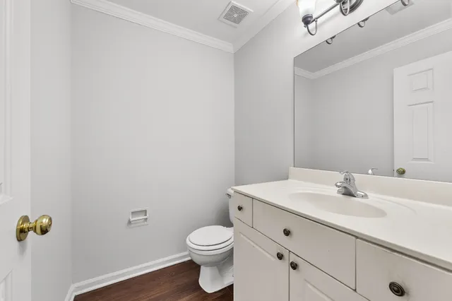 a bathroom with a sink mirror and toilet