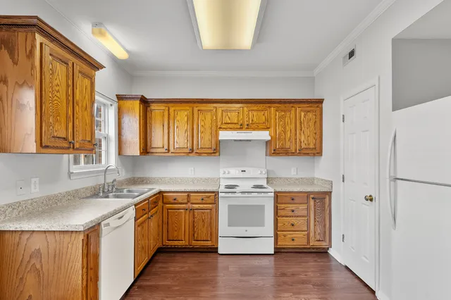 a kitchen with a stove a sink and a refrigerator
