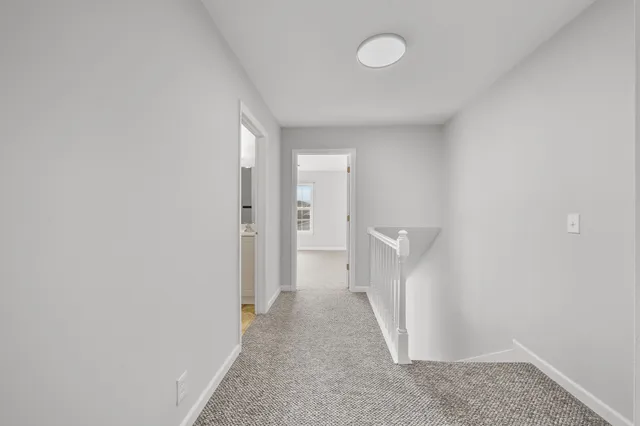 a view of a hallway with a white walls