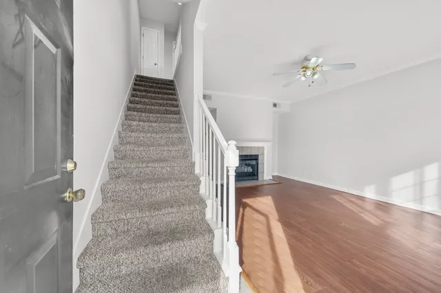 a view of entryway and hall with wooden floor