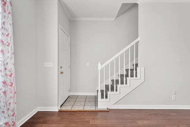 a view of an entryway with wooden floor