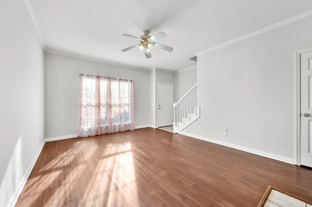 wooden floor in an empty room with a window