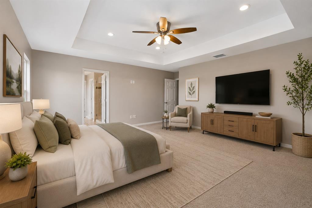 1192 Multiflora Loop Lutz, FL 33558 - Photo 17 of 32 a spacious bedroom with a bed and a flat screen tv