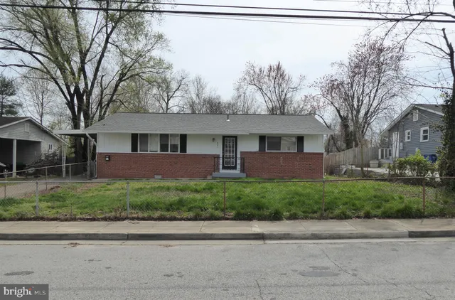 a front view of a house with a yard and a garage