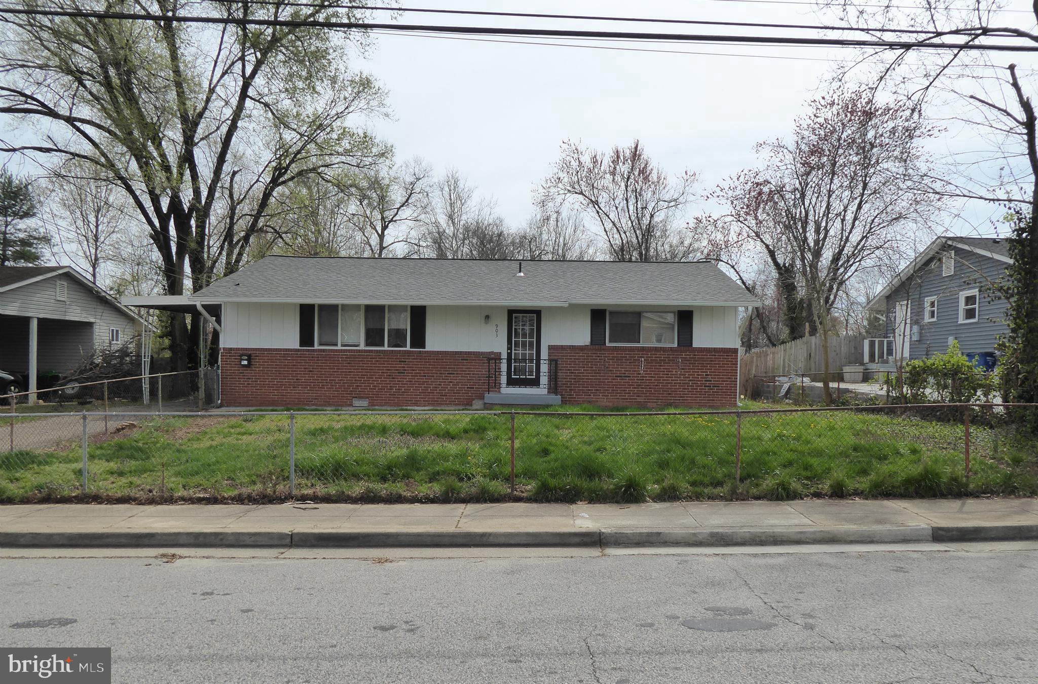 a front view of a house with a yard and a garage