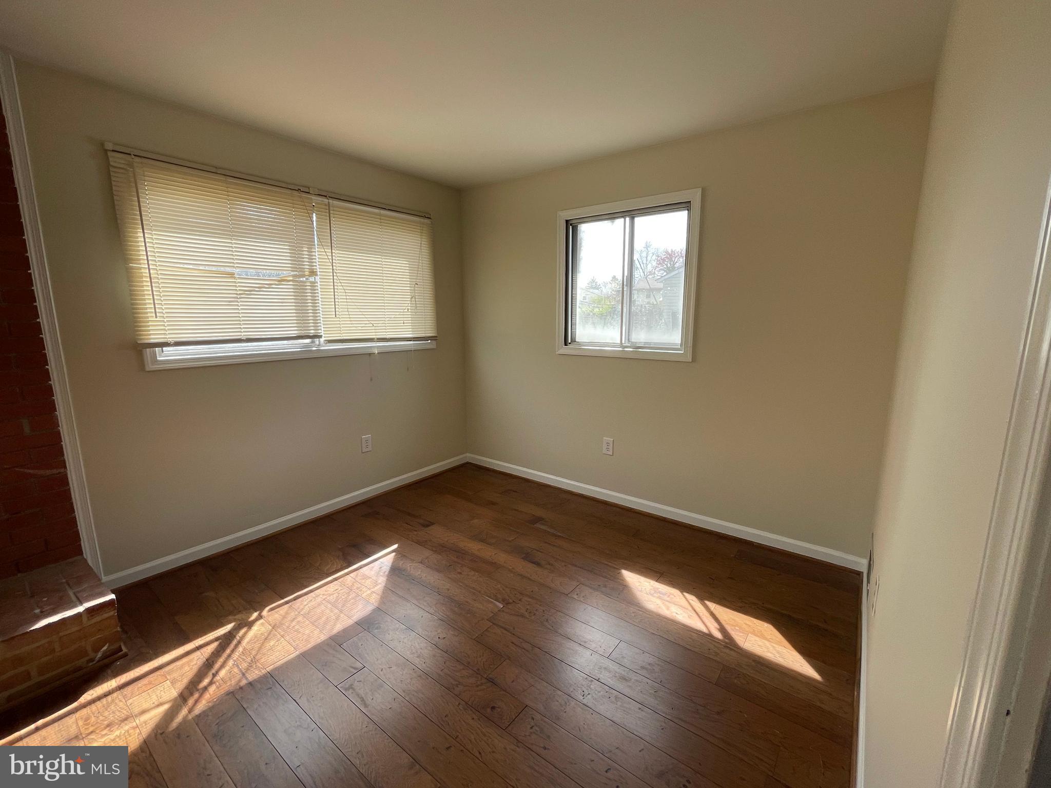 903 Regency Road Woodbridge, VA 22191 - Photo 16 of 38 an empty room with wooden floor and windows