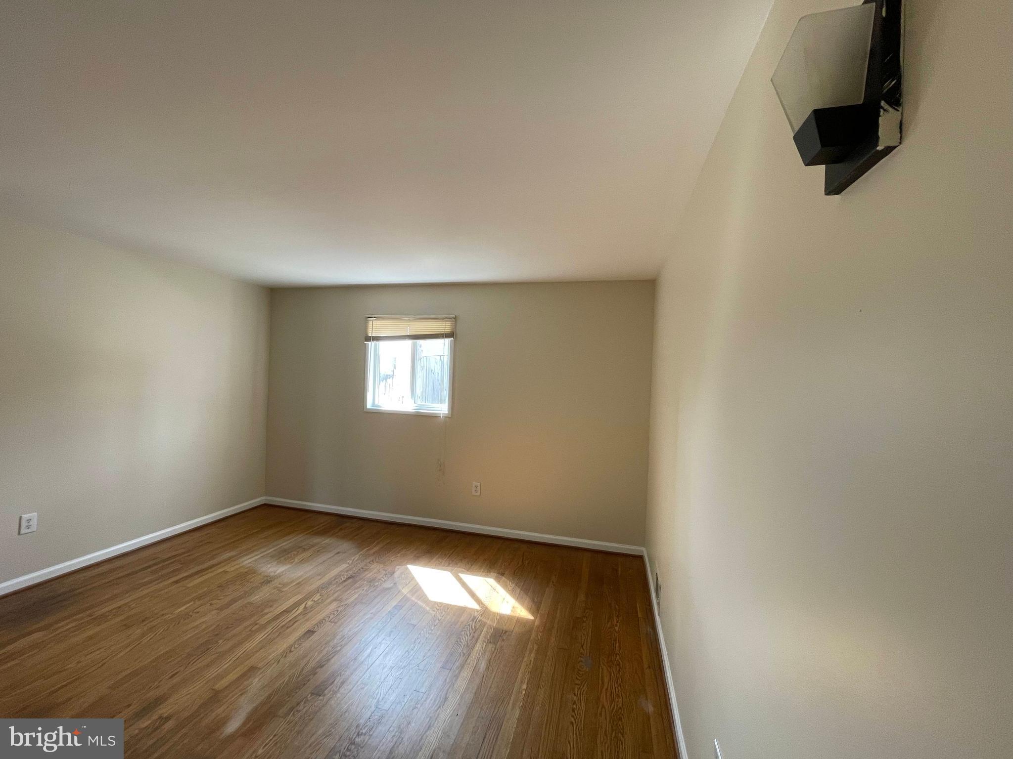 903 Regency Road Woodbridge, VA 22191 - Photo 22 of 38 an empty room with wooden floor and windows