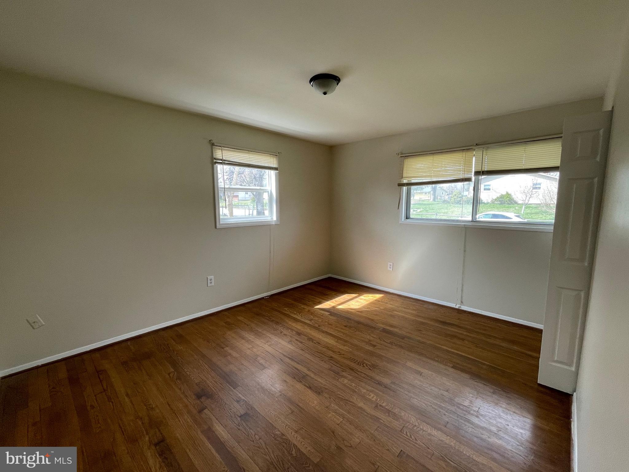 903 Regency Road Woodbridge, VA 22191 - Photo 24 of 38 an empty room with wooden floor and windows