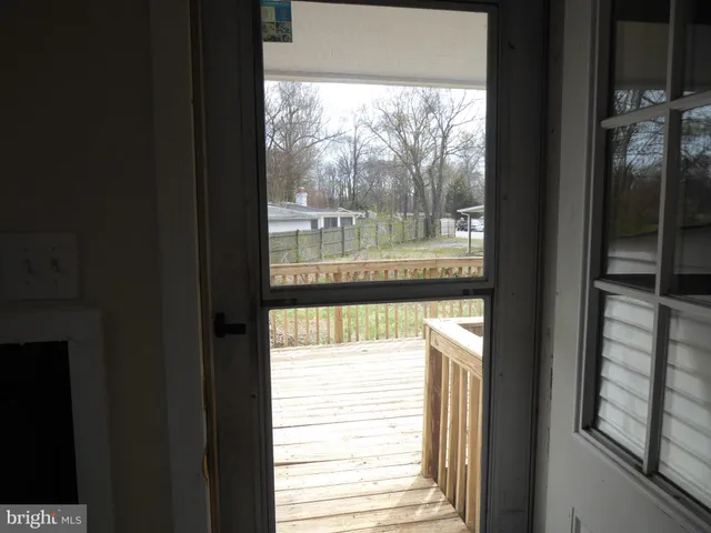 a view of balcony with wooden floor and seating space