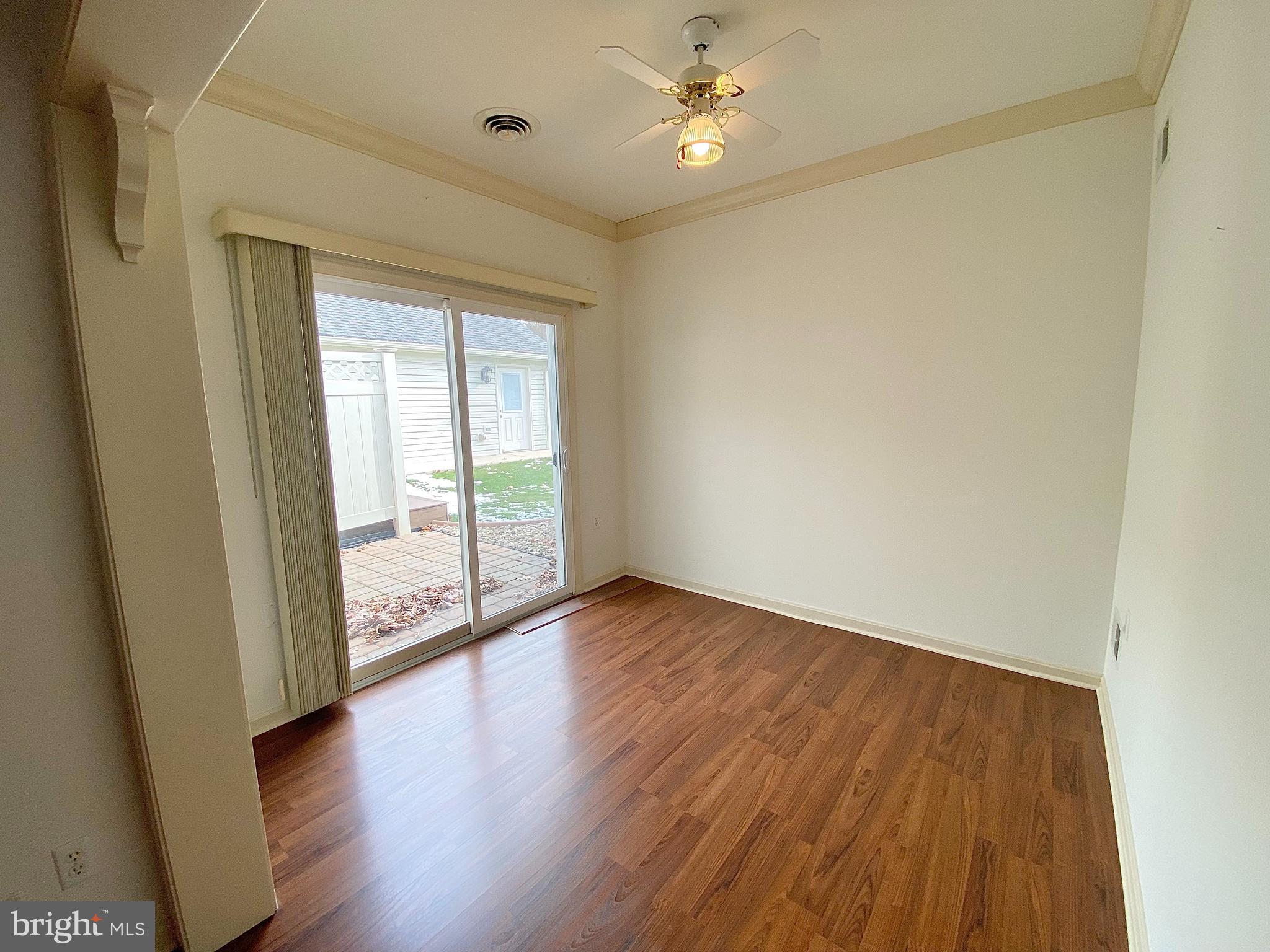 1476 Spring Side Drive East Chambersburg, PA 17202 - Photo 11 of 27 a view of an empty room with wooden floor and a window
