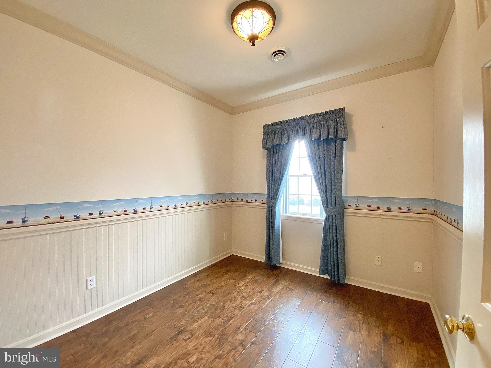 1476 Spring Side Drive East Chambersburg, PA 17202 - Photo 12 of 27 a view of an empty room with wooden floor and a window