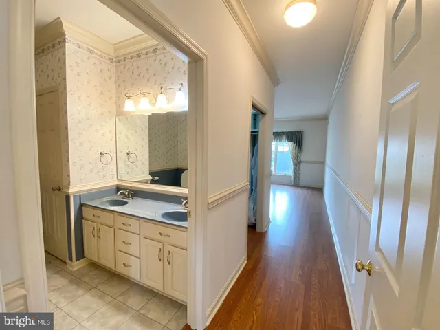a bathroom with a double vanity sink and mirror with shower