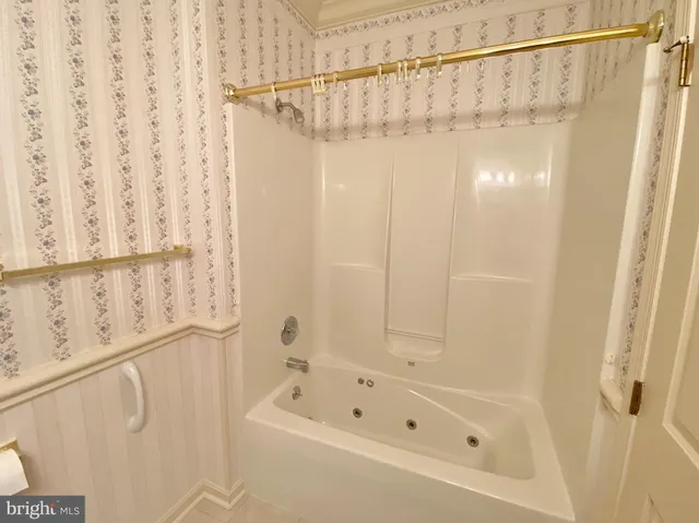 a bathroom with a shower curtain and a bathtub
