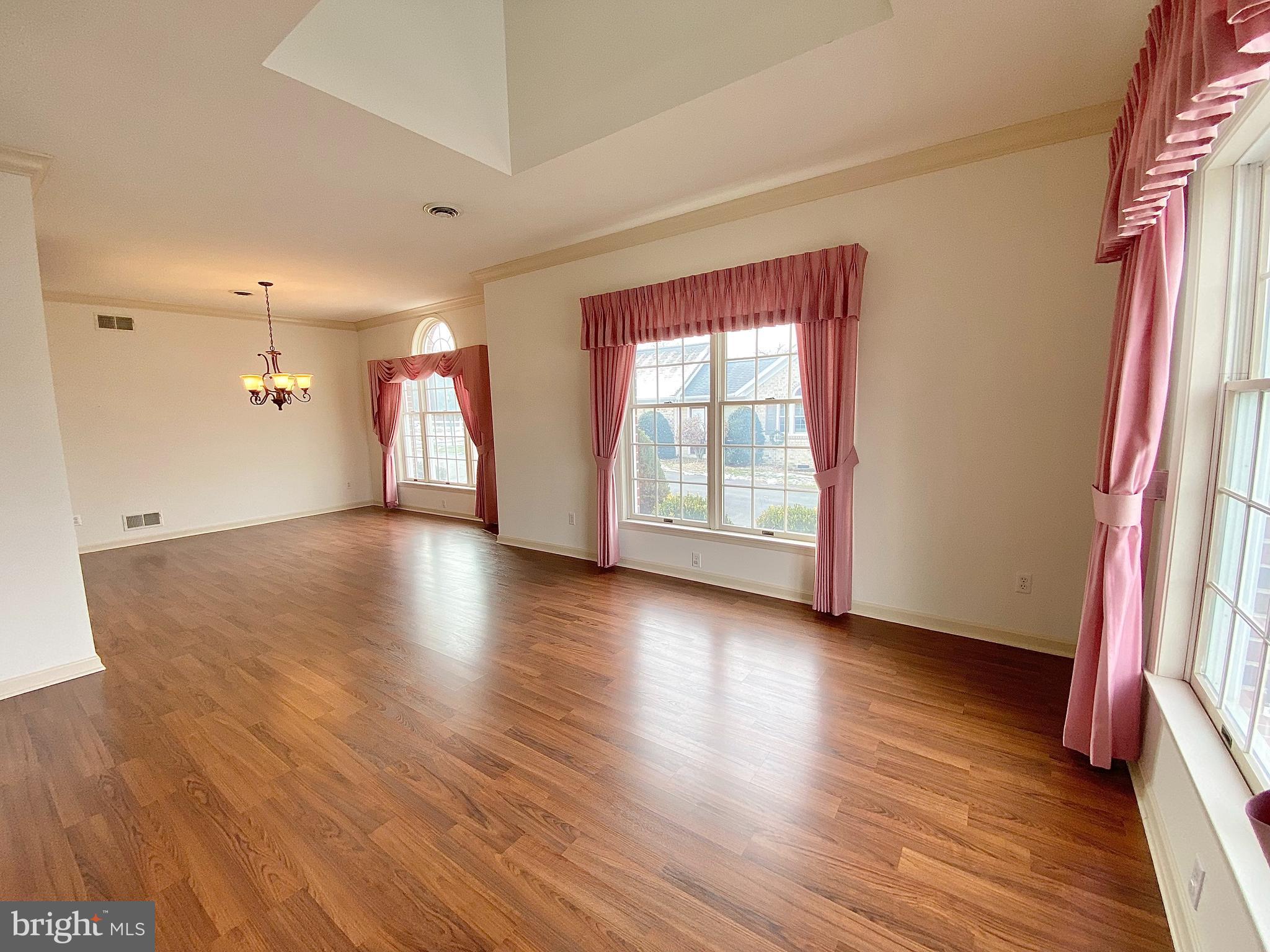 1476 Spring Side Drive East Chambersburg, PA 17202 - Photo 4 of 27 an empty room with wooden floor and windows