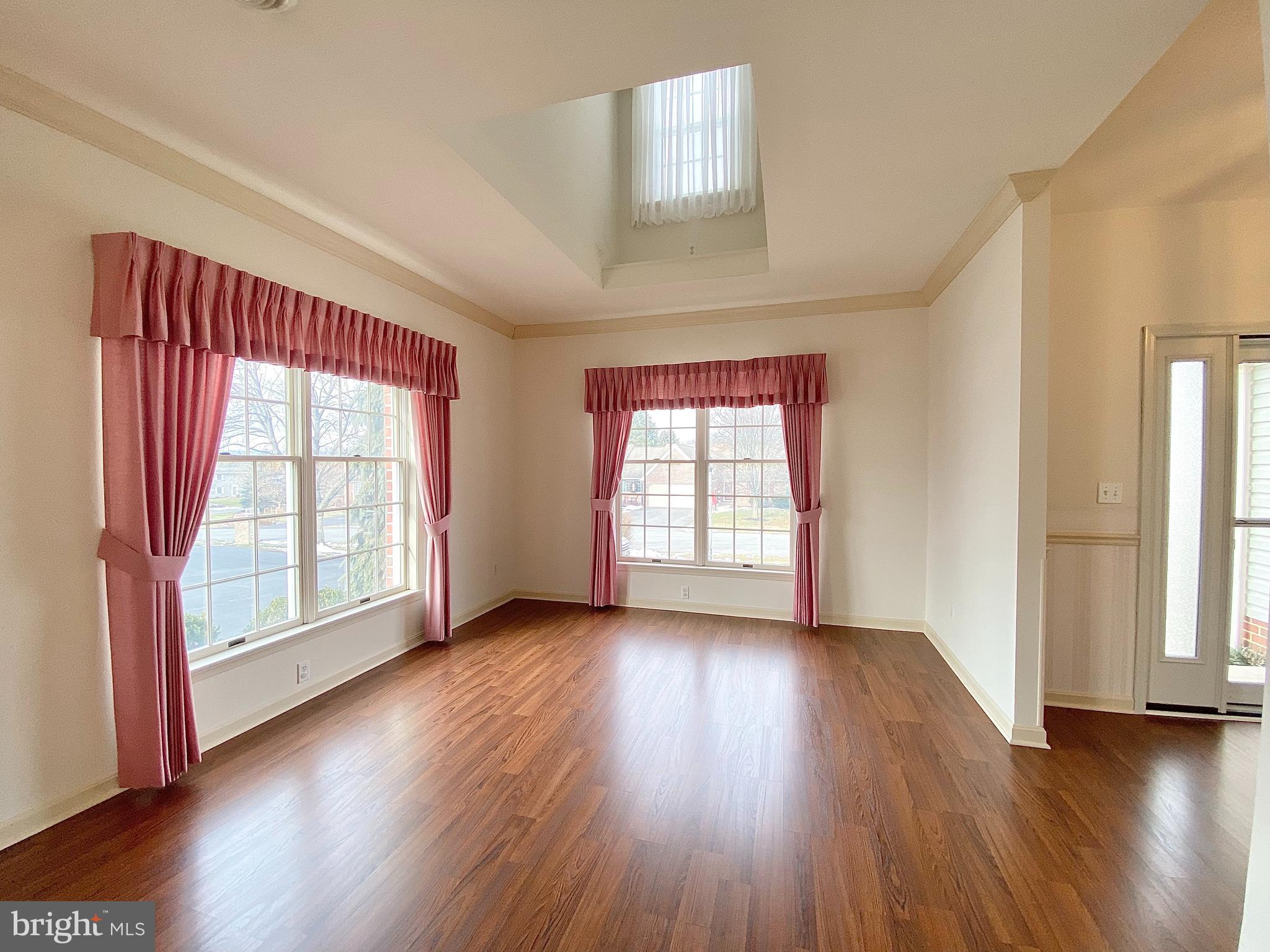 1476 Spring Side Drive East Chambersburg, PA 17202 - Photo 5 of 27 an empty room with wooden floor and windows