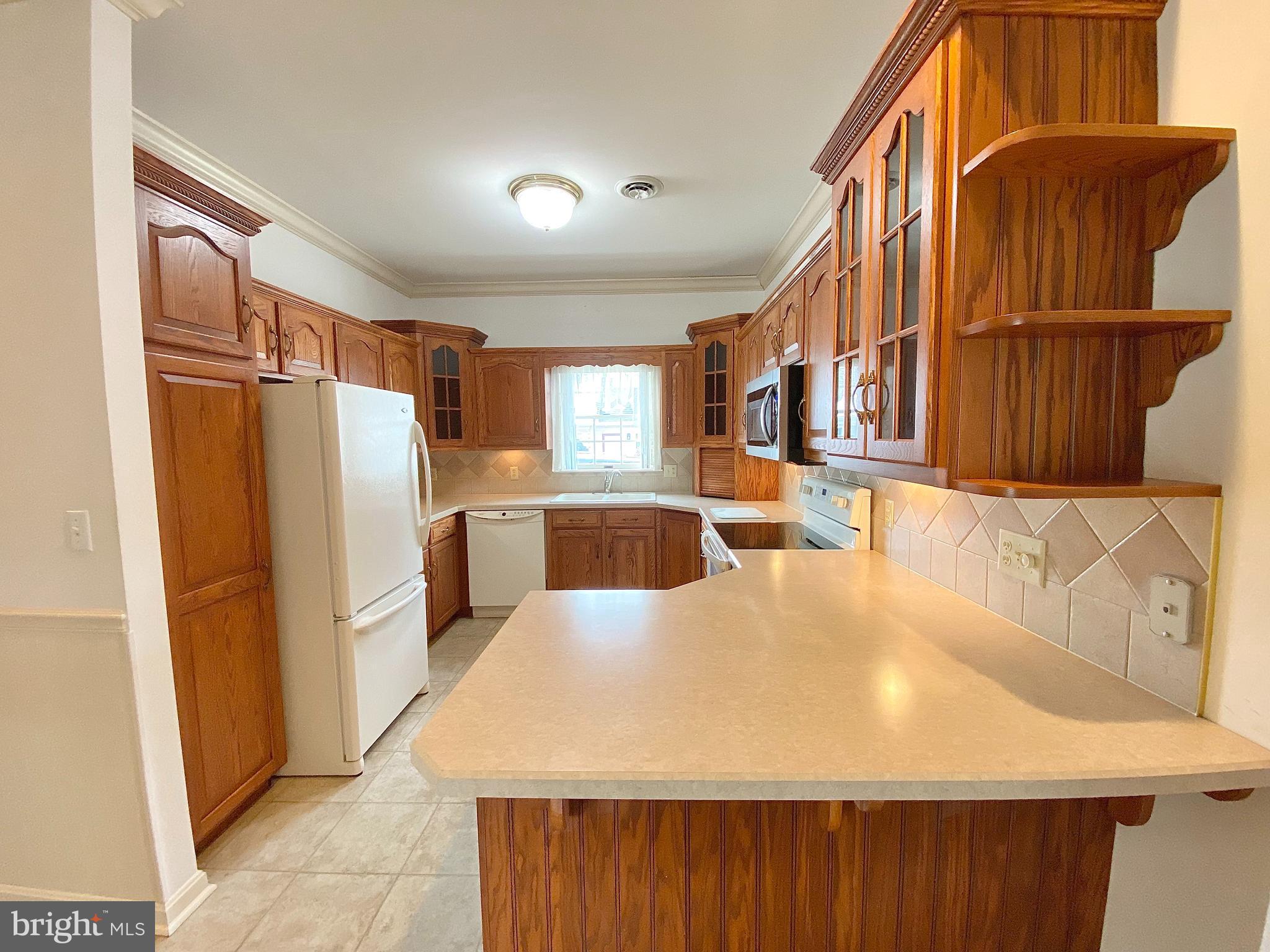 1476 Spring Side Drive East Chambersburg, PA 17202 - Photo 8 of 27 a kitchen with stainless steel appliances granite countertop a refrigerator a stove and a sink