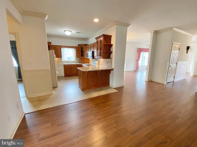 a view of kitchen with cabinets and wooden floor